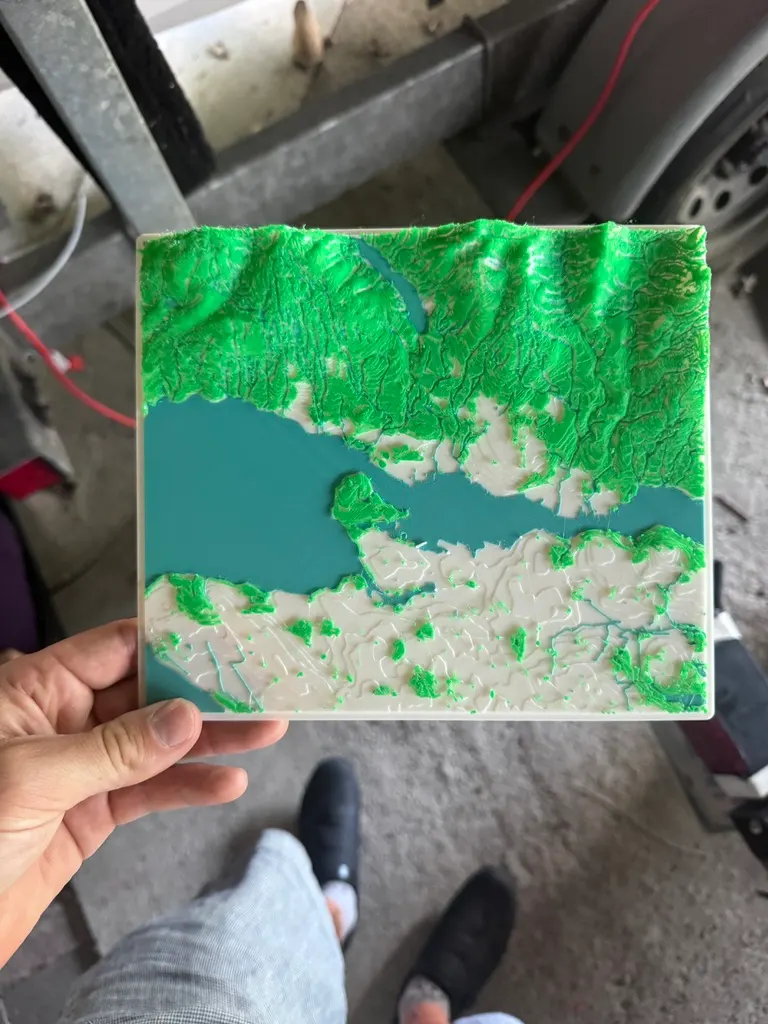 3D-printed relief map of Vancouver with green mountains and blue water