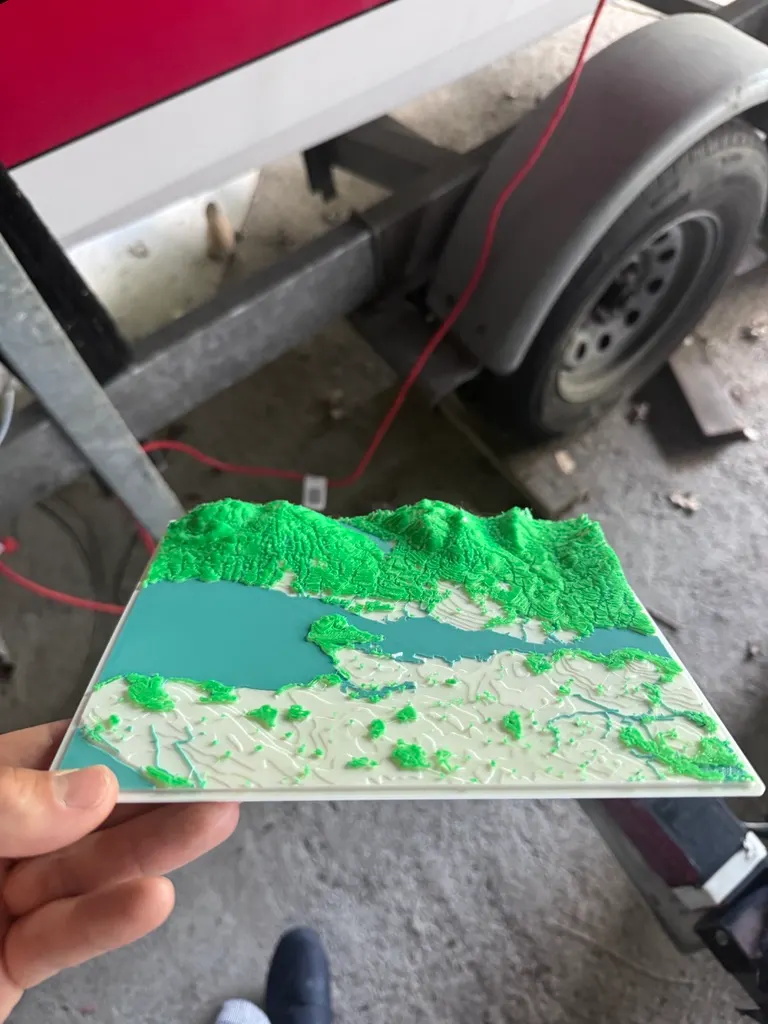 Angled view of the printed Vancouver relief map showing raised North Shore mountains